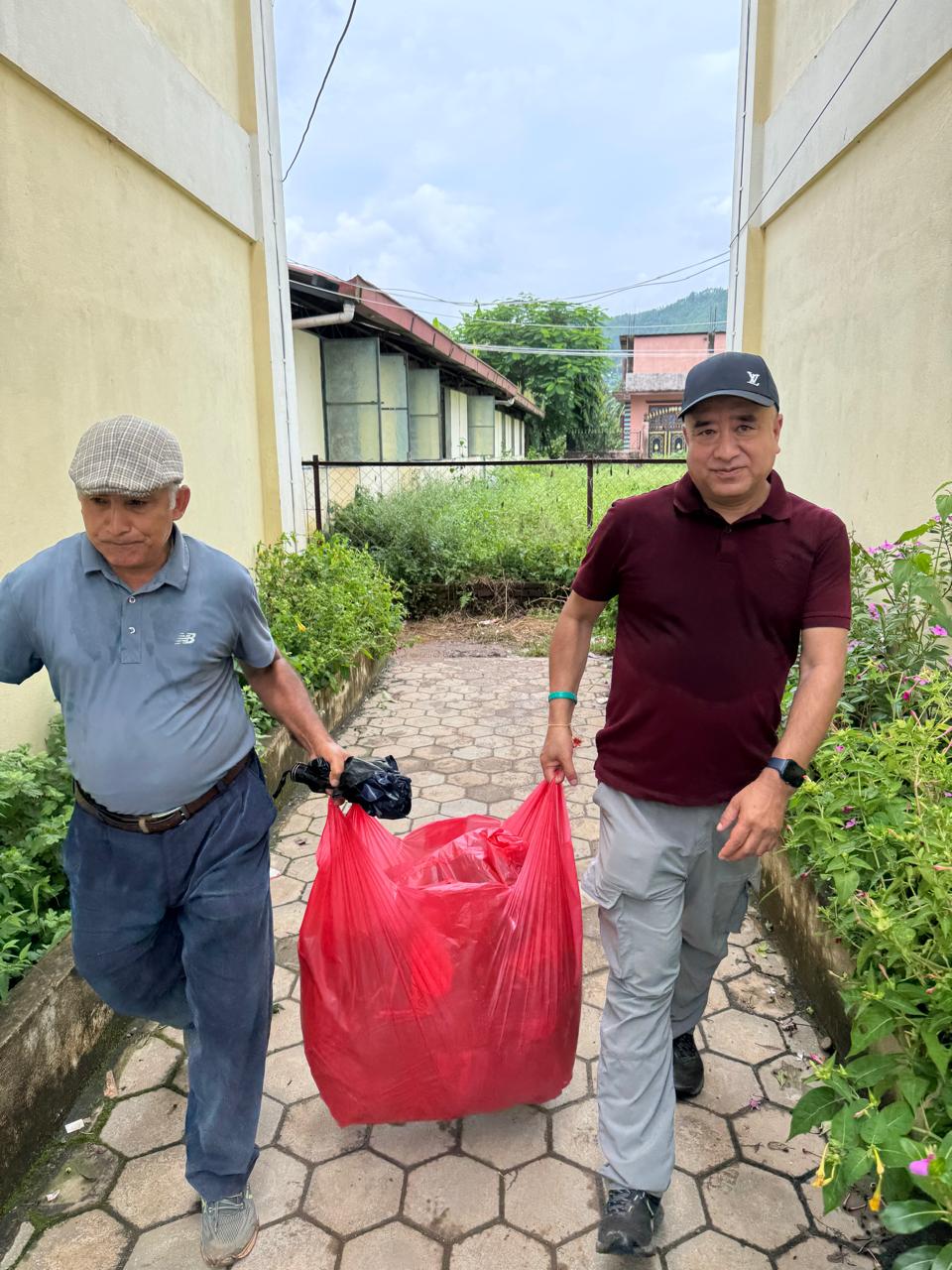 Carrying a bag of relief supplies toward distribution points.
